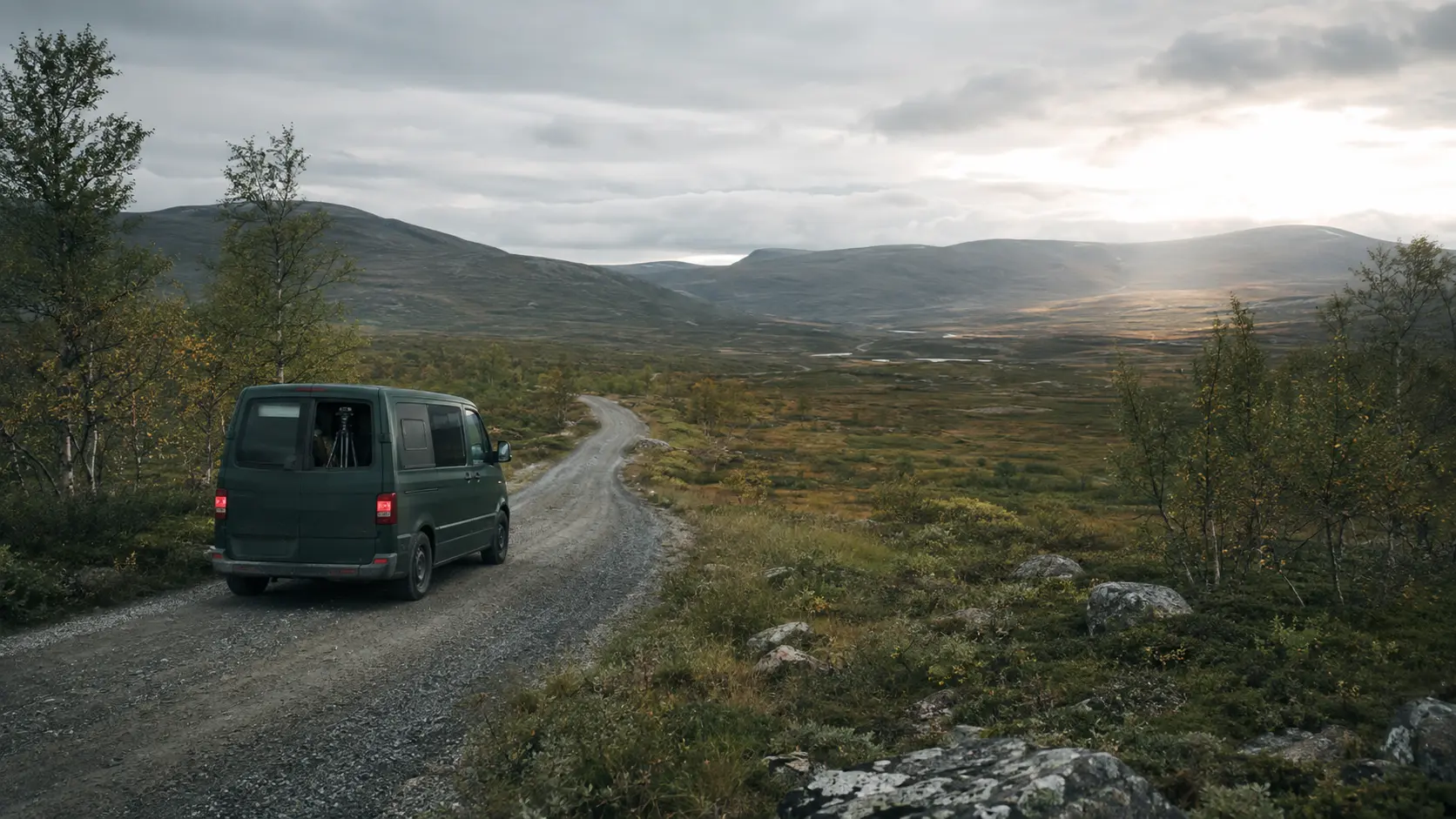 A practical field-documentation vehicle travelling through a northern fell landscape