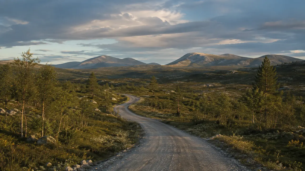 A northern road leading toward distant fells